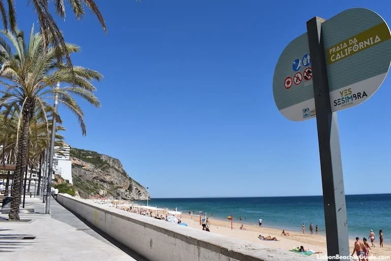 praia-de-sesimbra-promenade-view-umbrellas-ocean-lisbon-day-trip.webp
