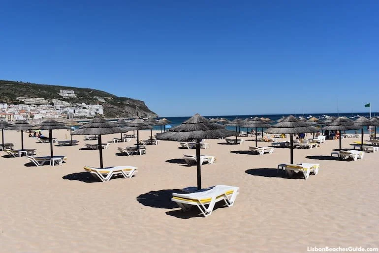 praia-de-sesimbra-umbrellas-sun-loungers-family-beach-lisbon.webp