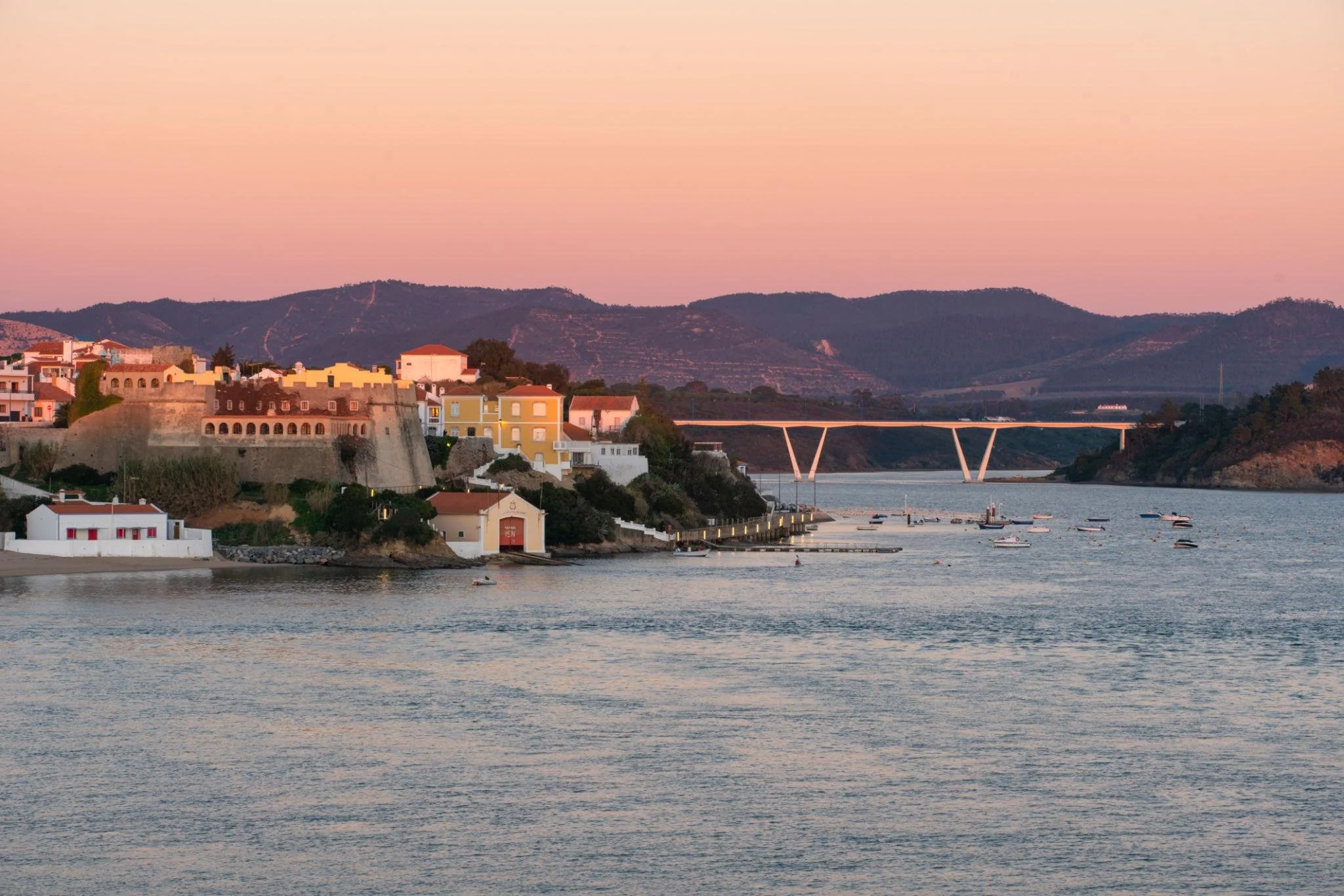 Sunset over the Mira River with Vila Nova de Milfontes in the distance on Portugal’s Alentejo coast.