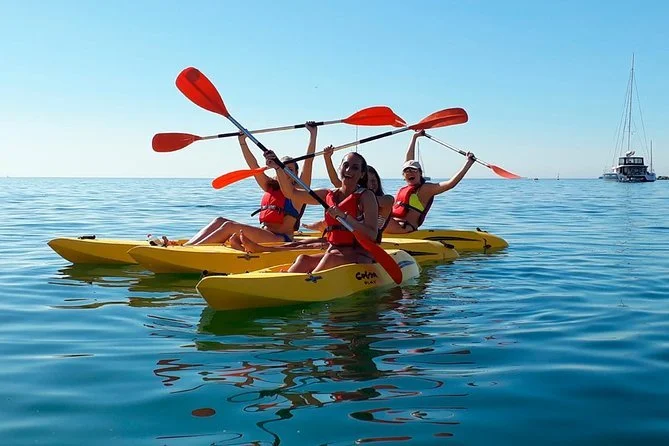 Kayakers having fun paddling through the crystal-clear waters of Cascais on an unforgettable kayak tour, exploring the stunning coastal regions of Portugal