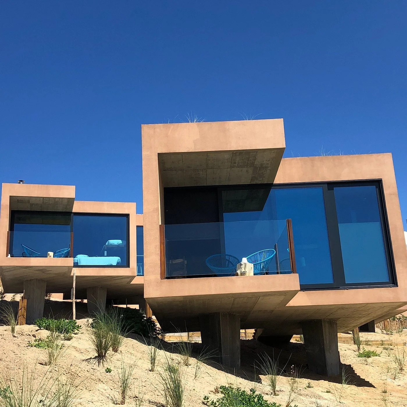 Noah Surf House in Santa Cruz, Portugal, perched on a cliff with ocean view
