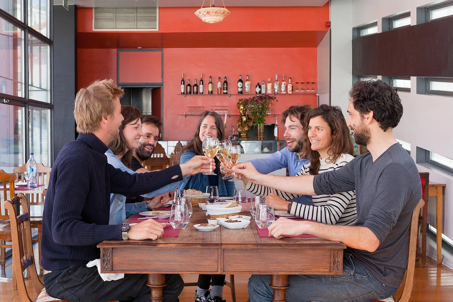 Friends toasting to a fabulous night out on Lisbon Food and Fado Tour