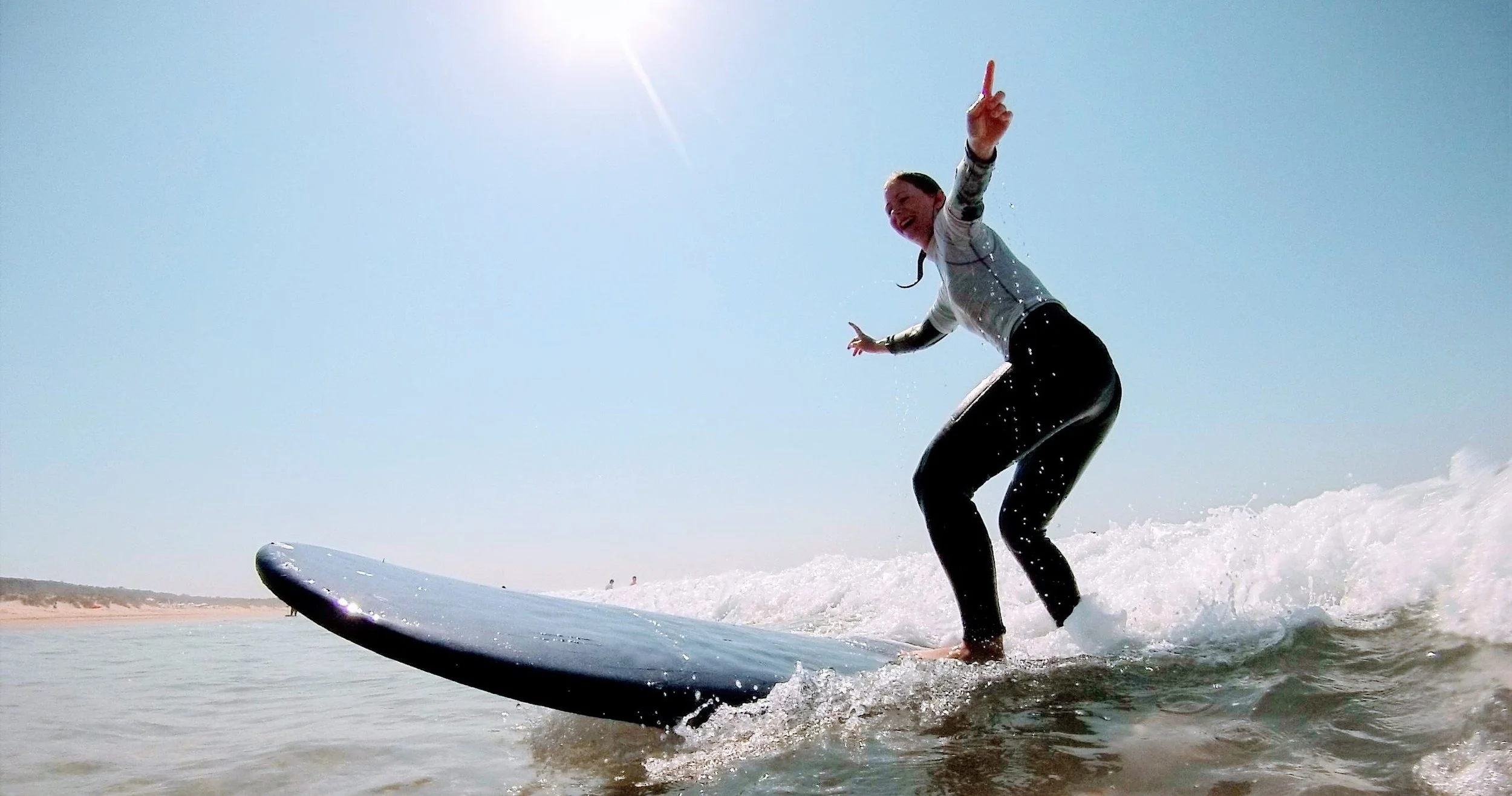 A person surfing waves on Costa da Caparica on the Lisbon Surf and Wine Tour
