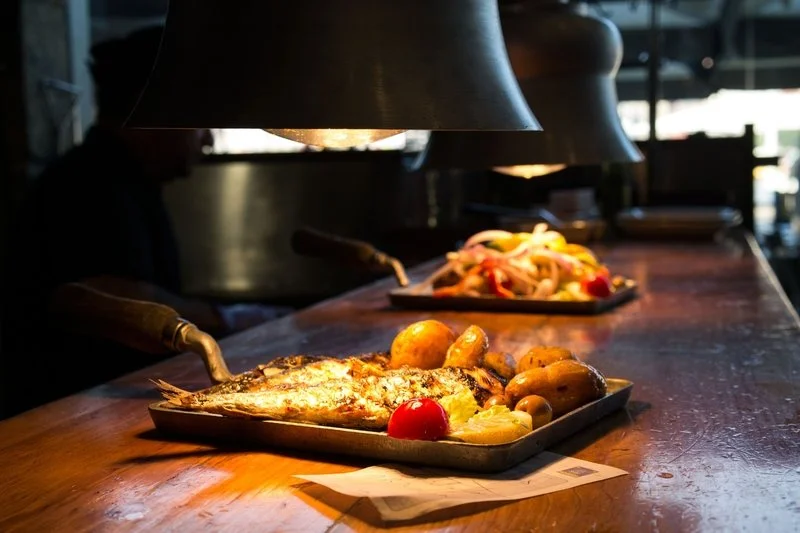 Fresh grilled fish served with boiled potatoes at a restaurant in Porto, Portugal
