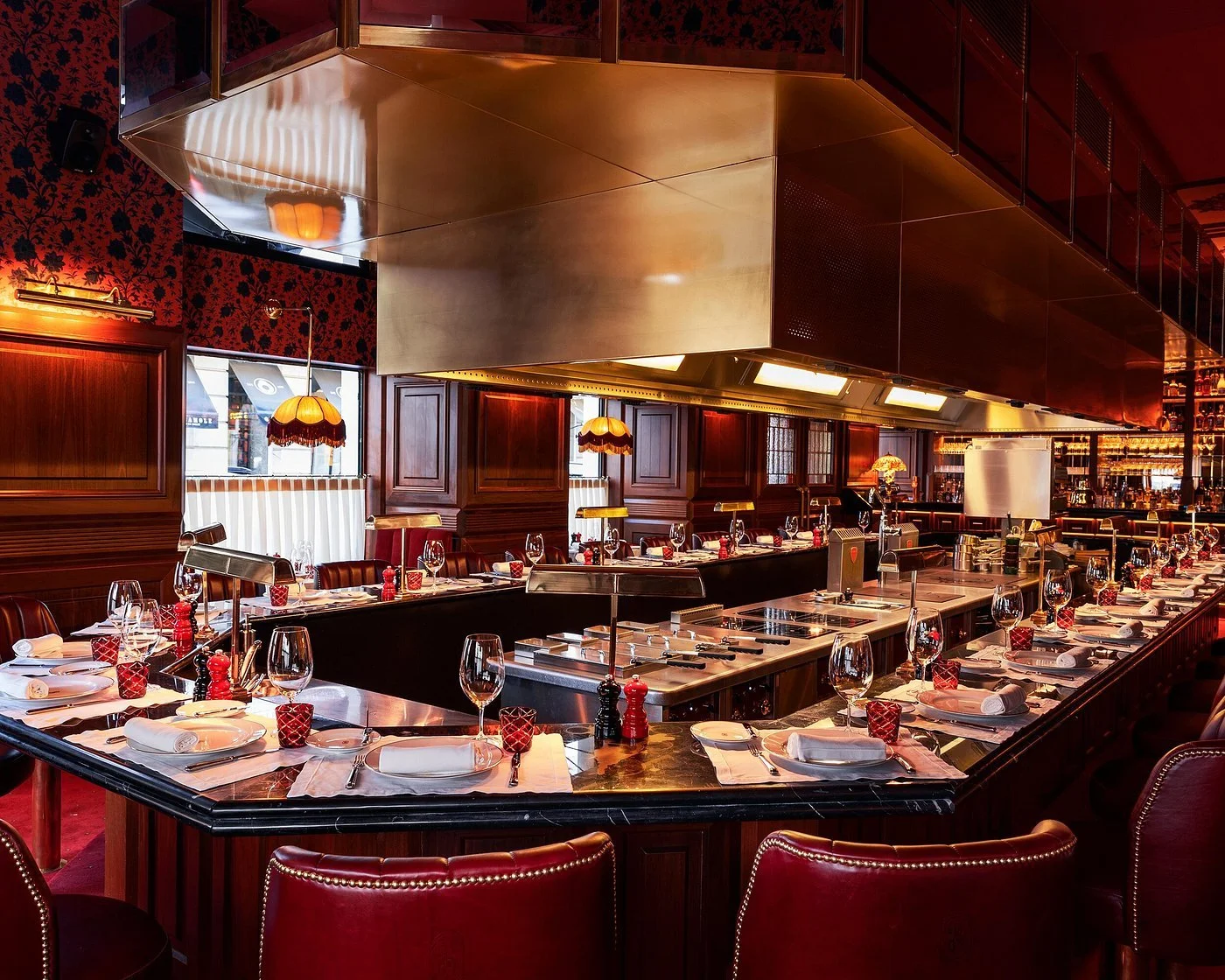 A communal bar table situated around a central prep station at Lisbon's classic French restaurant Brilhante.