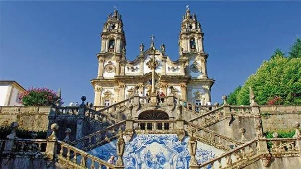 Sanctuary of Nossa Senhora dos Remédios in Lamego, Portugal, featuring its ornate Baroque church and grand staircase overlooking the surrounding Douro Valley landscape