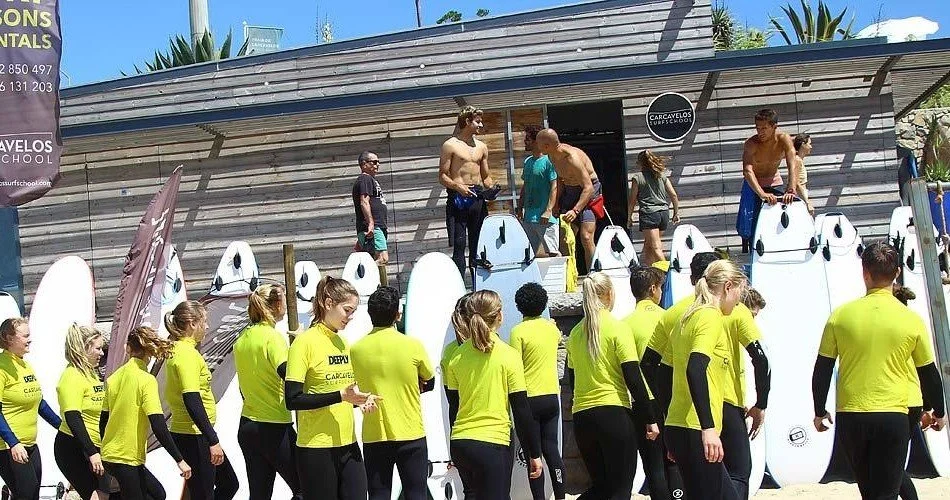 Expert surf coaches and surfers preparing for a day on the waves, ensuring a safe and enjoyable surfing experience.