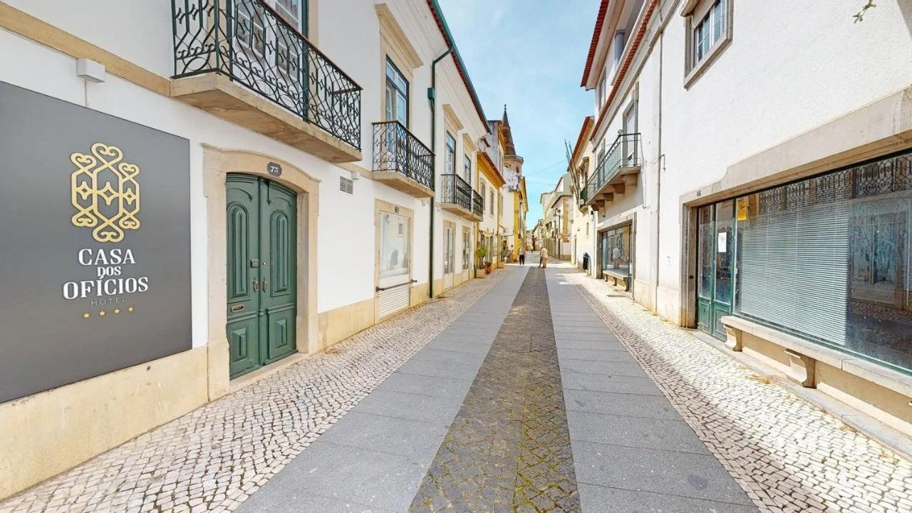 Narrow Portuguese Street with Cobblestone Path and Historic Buildings Surrounds Casa dos Ofícios Hotel.