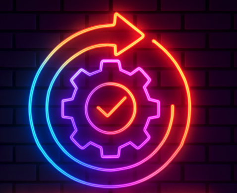 Neon sign of a gear inside a circle with an arrow, symbolizing process or automation, against a brick wall background.