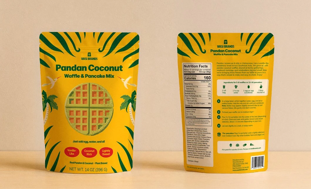 Front and back views of the Wasi Brands Pandan Coconut Waffle & Pancake Mix package, featuring illustrated branding on the front and nutrition, ingredients, and preparation information on the back.