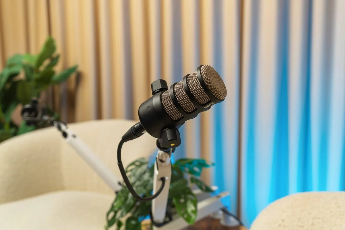 Professional microphone setup with curtain backdrop and adjustable accent lighting.
