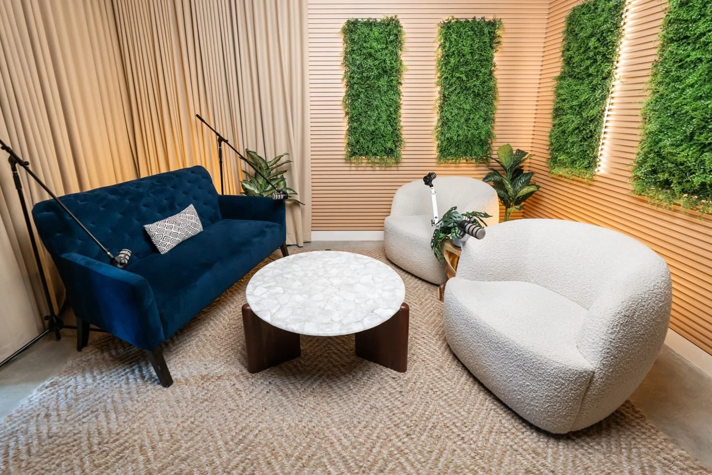 Sofa and chair layout with a greenery backdrop for group conversations.