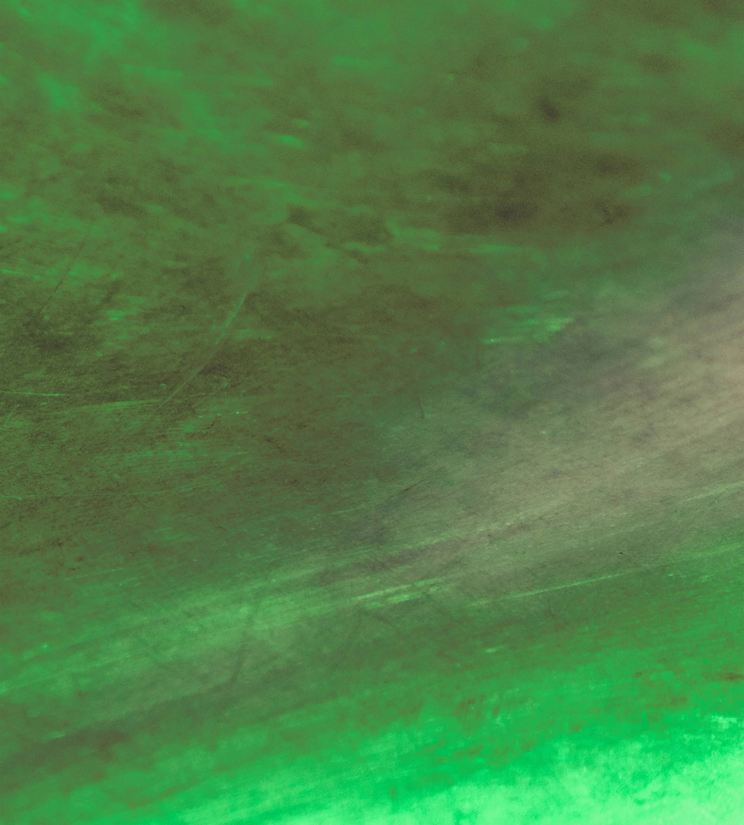 Green laser lights projected onto a textured surface.