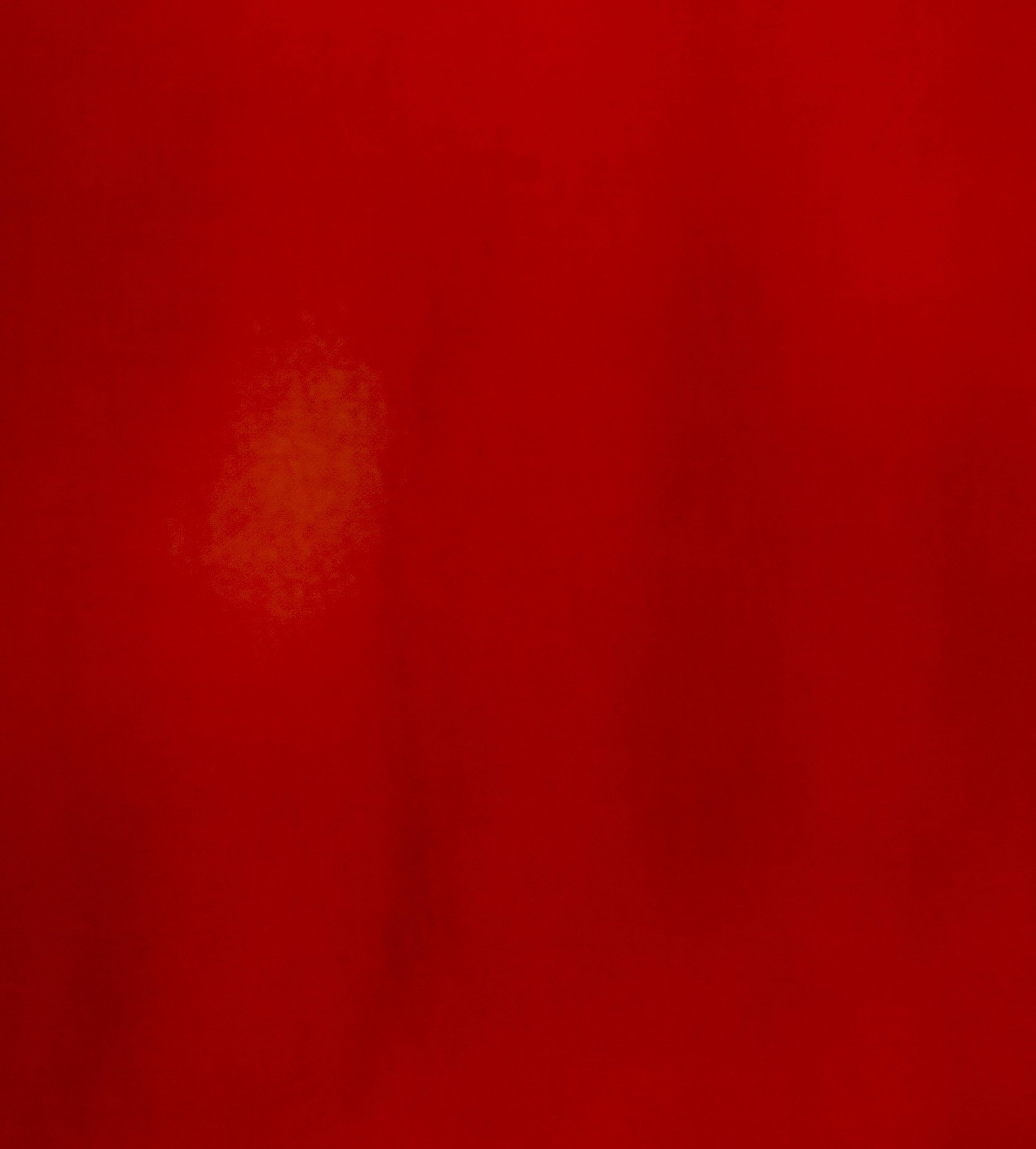 A close-up of a red object with a slightly textured surface.