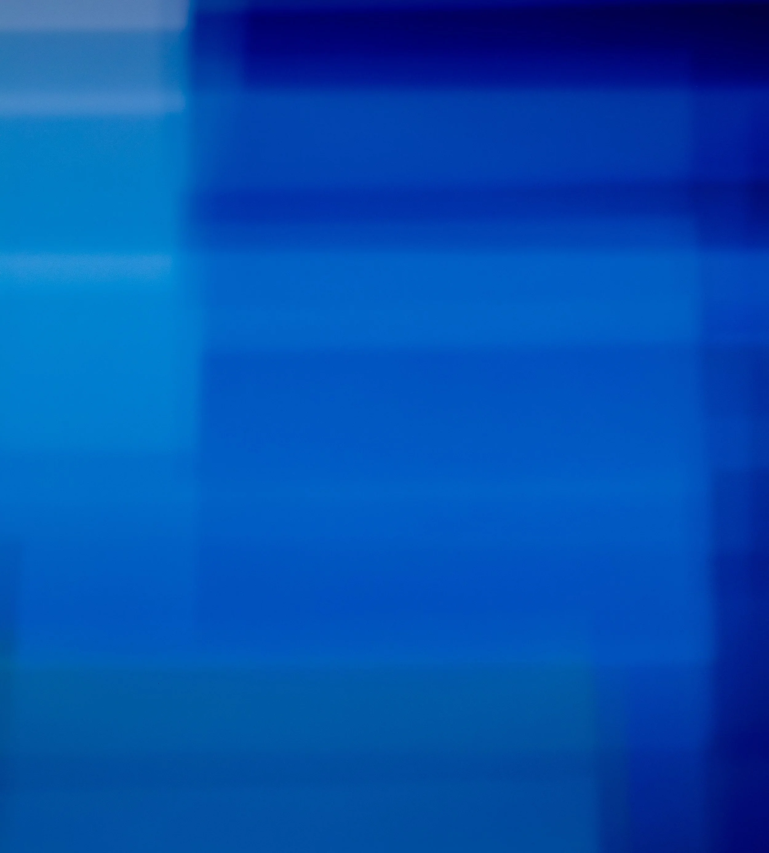 An extremely blurred image with shades of blue.