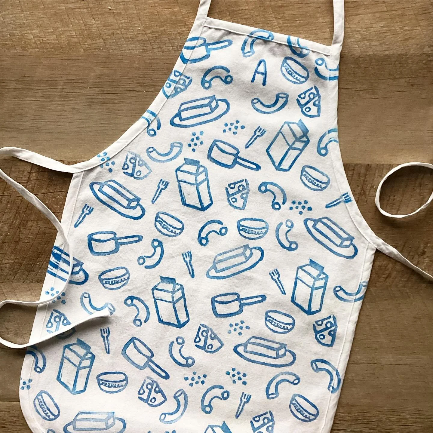 The girls and I did a pizza cooking class last week and I got the idea to hand stamp a kids apron with my 8 year olds favorite recipe, mac and cheese. What do you think? Could this be one of my first official products with Little Lightning Co.?