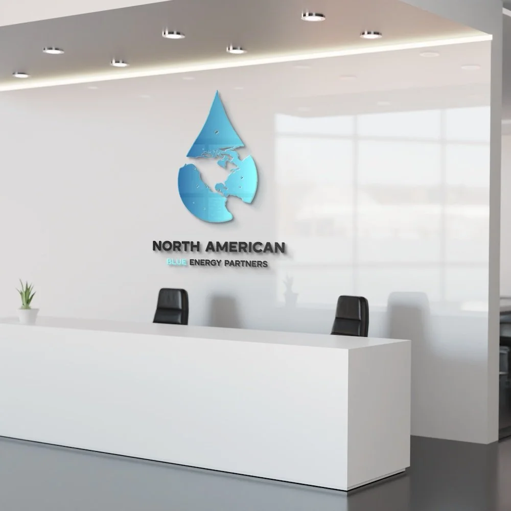 Modern office reception area with a white desk, black chairs, and a wall logo of a water drop with the North American map inside it, labeled as North American Blue Energy Partners.