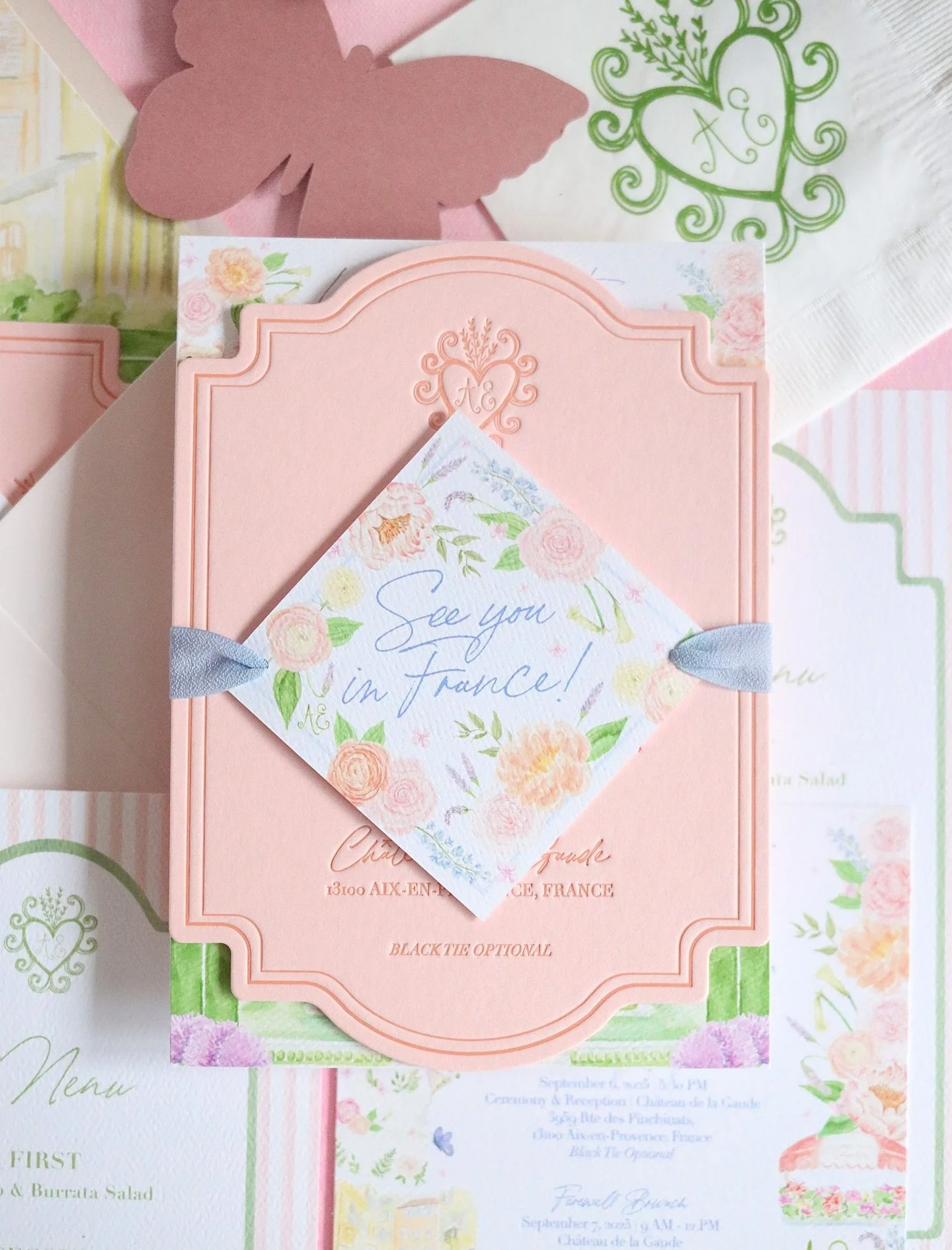 A line drawn crest, pastel stripes, and everything nice tied with a ribbon. 

This French estate wedding is beyond dreamy. The French blue stripes and layered collage of illustrations add elements of whimsy, while the letterpress invitation instantly