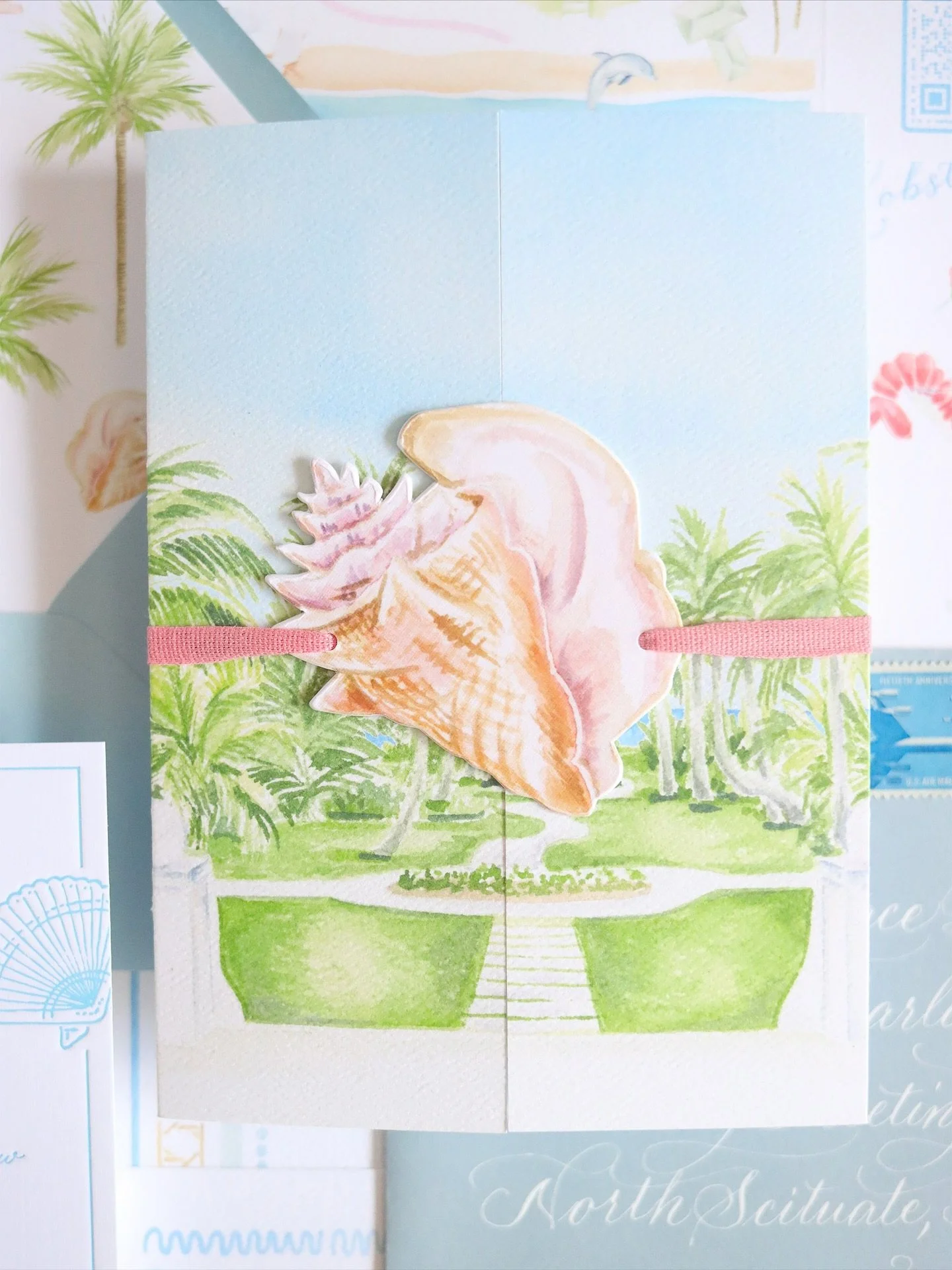 Open this Bahama Beach Club wedding invitation with me! 

Let&rsquo;s take a moment to admire&hellip;okay, now we can untie the conch shell and pink linen ribbon. Inside the gatefold you&rsquo;ll find watercolor artwork of the venue and a detailed ti