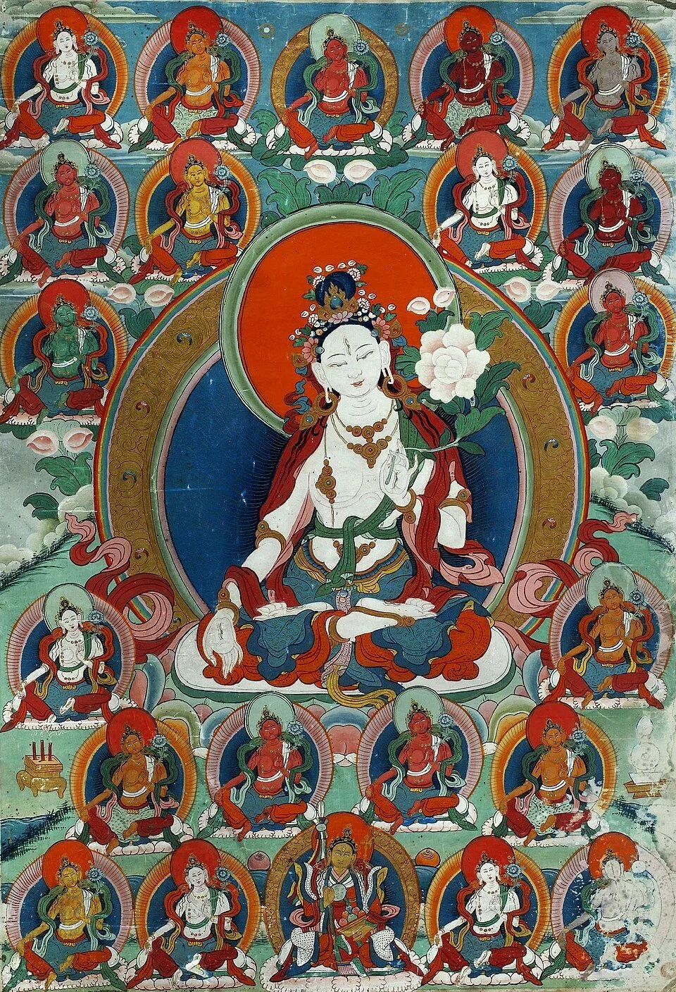 Thangka painting featuring a central figure of a white deity seated on a lotus, surrounded by multiple smaller colorful deities, clouds, and mountains in the background.