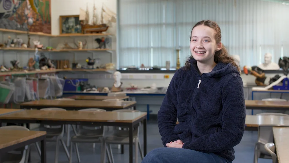 Rockbrook International student sharing her experience during an interview in a classroom