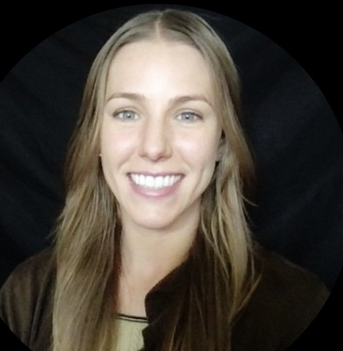 A young woman with long blonde hair and blue eyes, smiling with white teeth, against a black background.