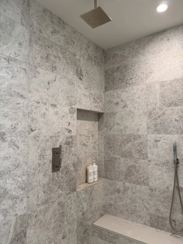 Large-format stone walk-in shower with niche
