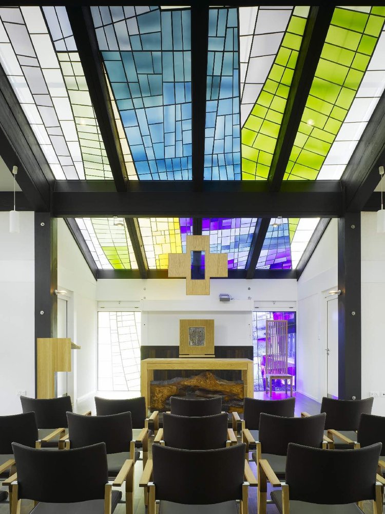 Stained-glass skylight in blue, green and violet above the chapel altar, set into the roof panels