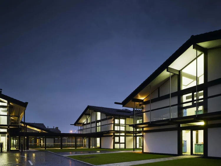 The bedroom wings at night, two floors of rooms around a lawn