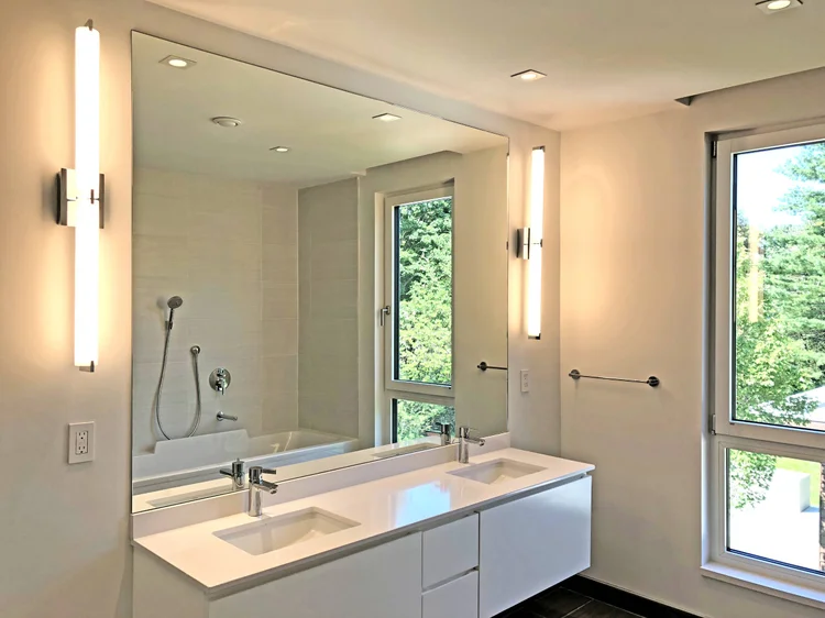 Double vanity between tall windows