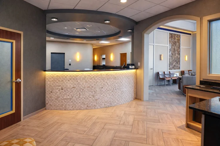 Reception desk of a dental office under a curved ceiling