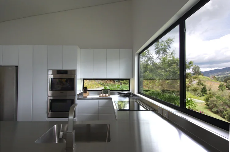White cabinets, stainless steel countertop and a picture window, Medellín