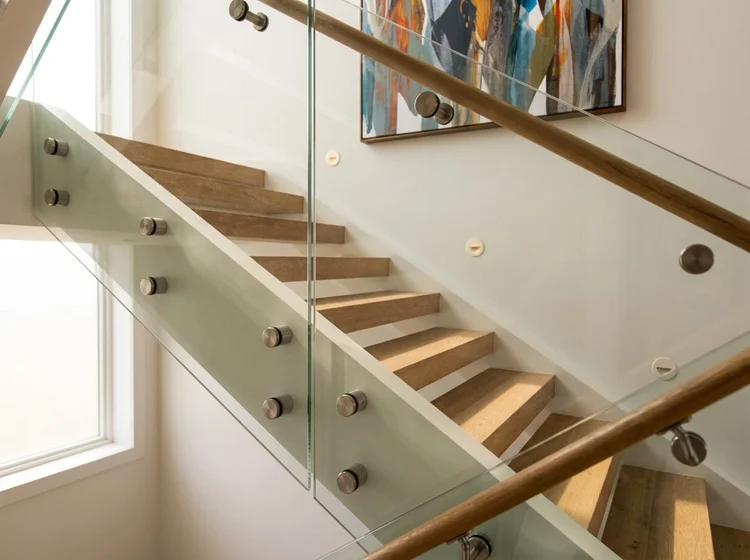 Oak stair with a frameless glass balustrade on stainless steel standoffs and a wood handrail