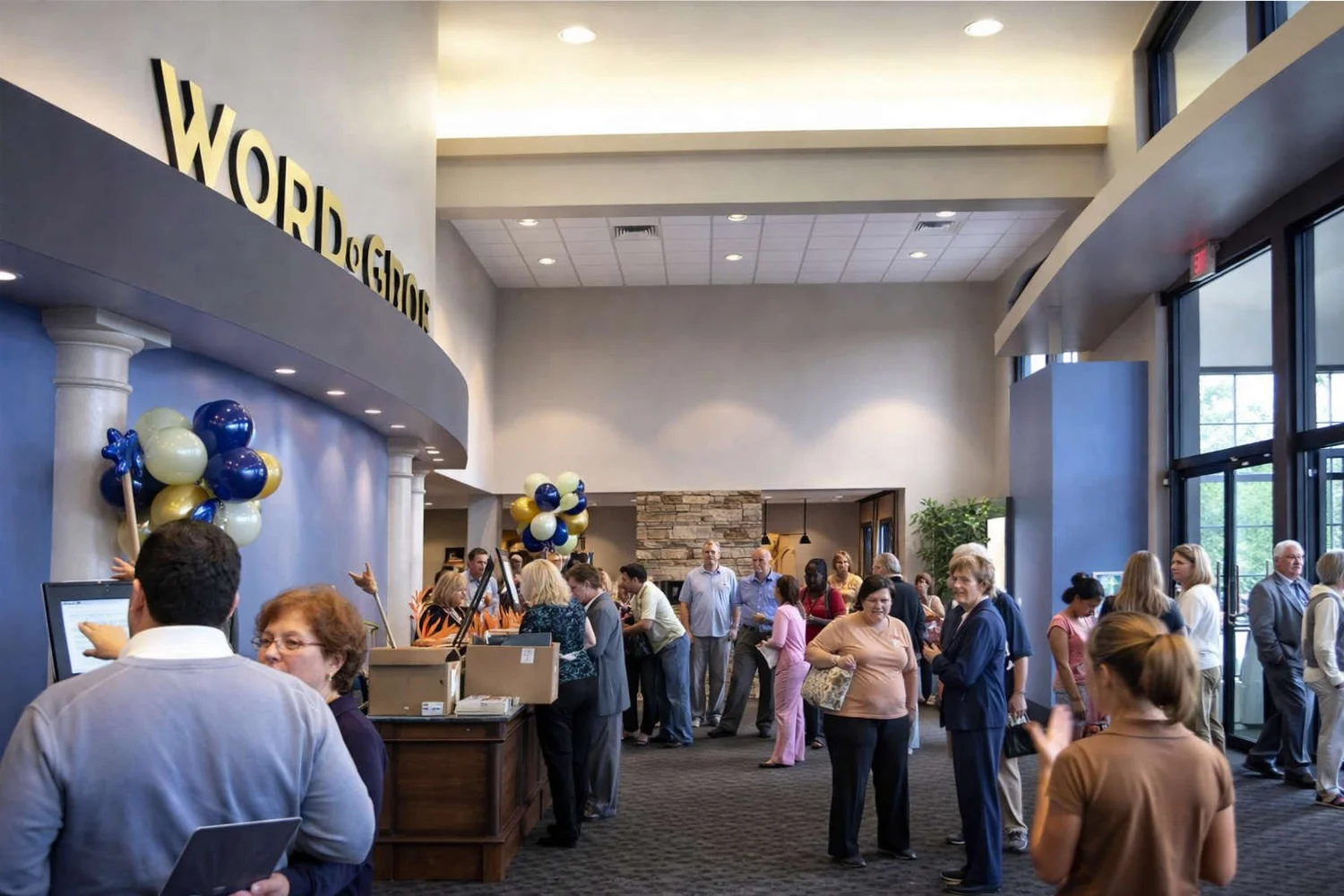 Lobby of Word of Grace Church with the church name on a curved wall and members gathering