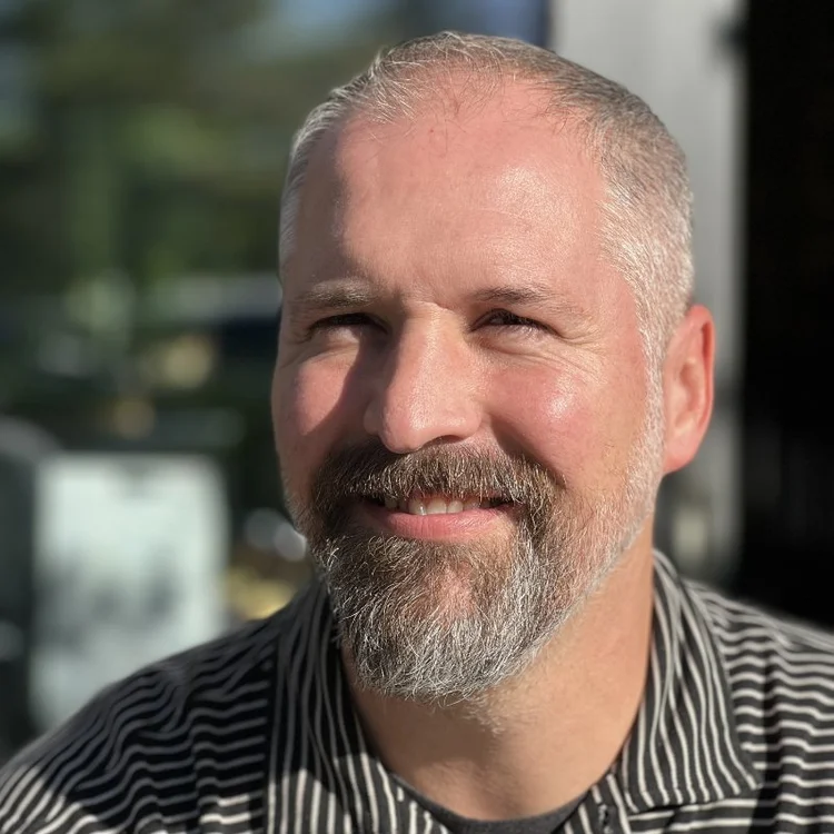 Portrait of Rob Shearer, smiling outdoors