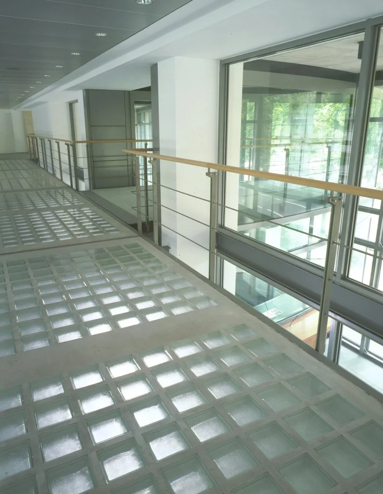 A glass-floored bridge across the hall