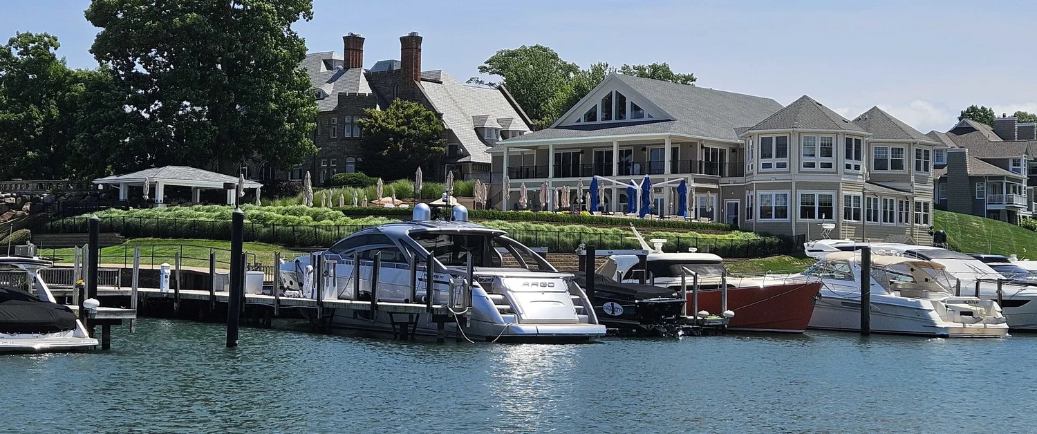 Shoreby Club seen from the marina on Lake Erie, with boats in the foreground and the historic estate house on the hill