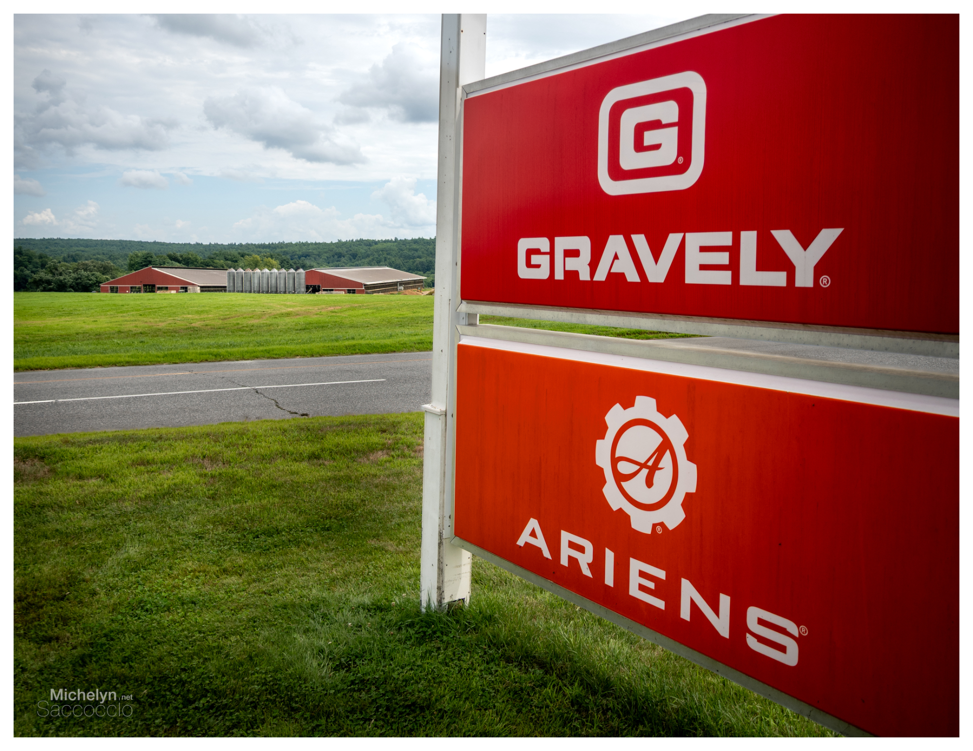 commercial-sign-red-barns-silos-green-hills.webp