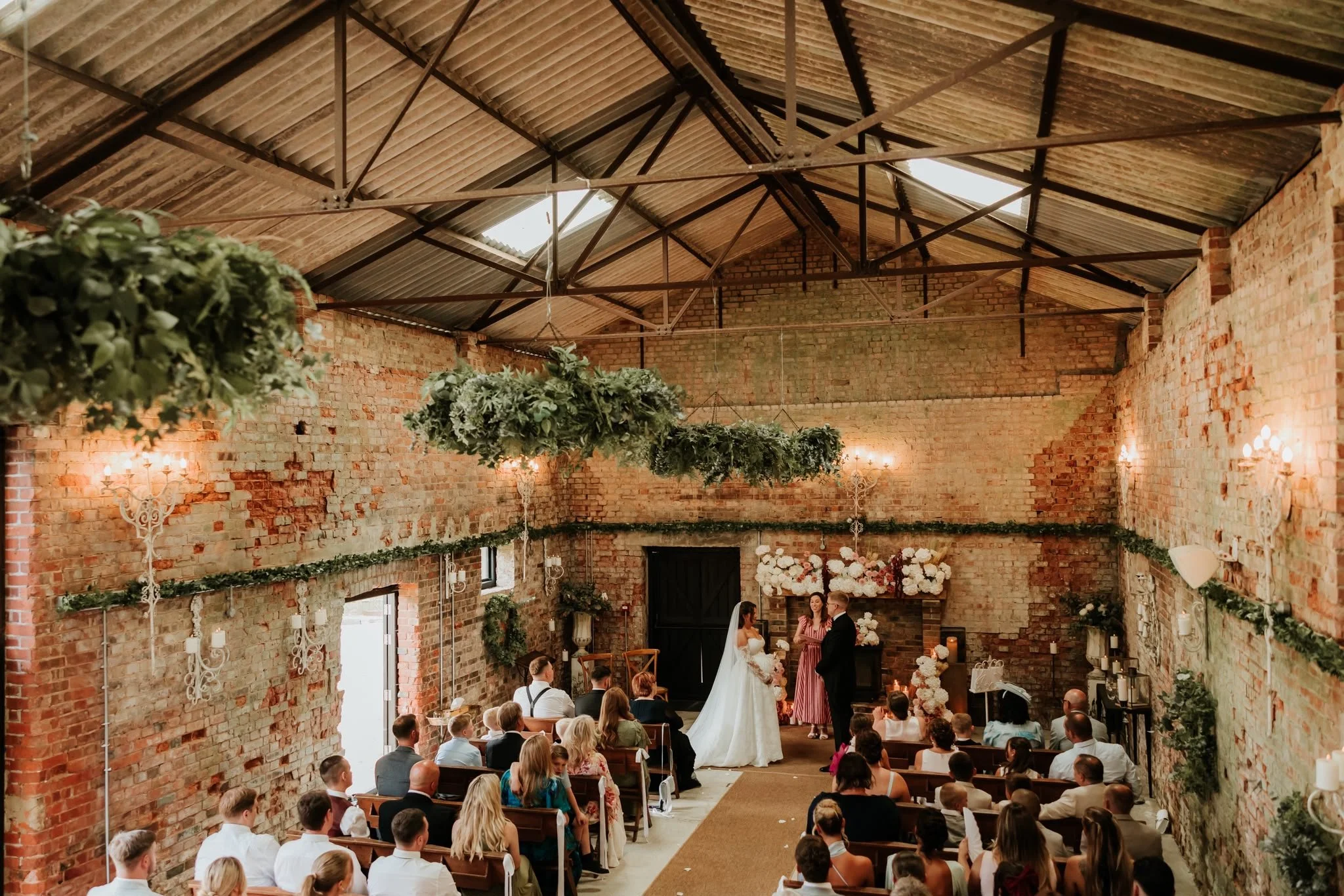 A couple marrying in a celebrant-led wedding ceremony by an independent wedding celebrant in Surrey at The Barn at Botley Hill. Photo: Hannah Mcgregor