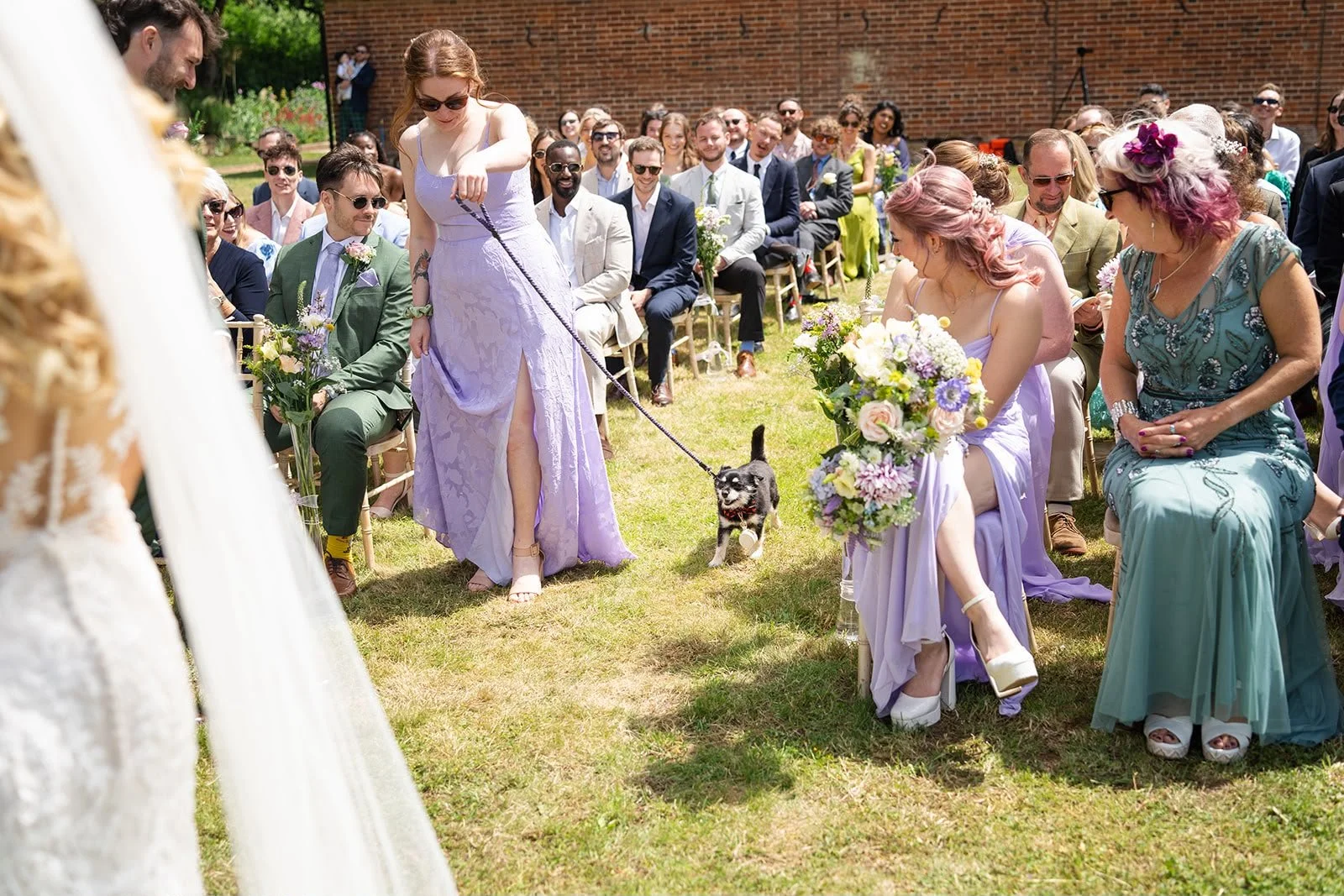 Bridesmaid walks dog down the aisle as a ring bearer within a personal wedding ceremony led by an independent wedding celebrant creating and delivering wedding ceremonies in Surrey and South East England. Photo: Soulful Reflection