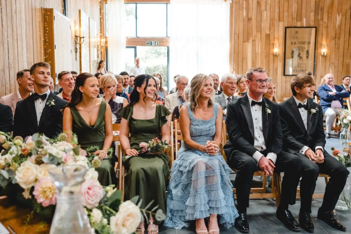 Wedding guests enjoying their celebrant-led wedding ceremony by a wedding celebrant based in Surrey at Chafford Park, Kent. Photo: Parkershots