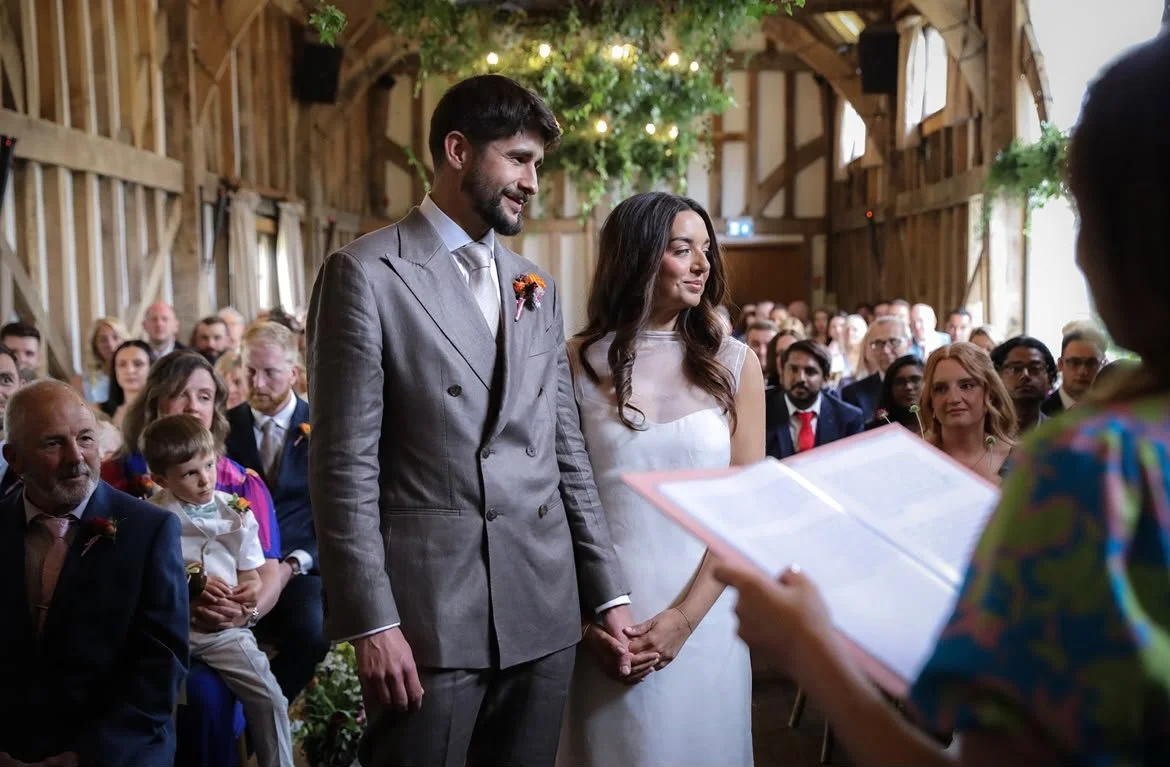 A gorgeous couple looking lovingly at their family and friends during their wedding ceremony at Gate Street Barn in Surrey as their wedding celebrant led their beautifully authentic and simple wedding ceremony.
Photo: VLA Wedding Photography