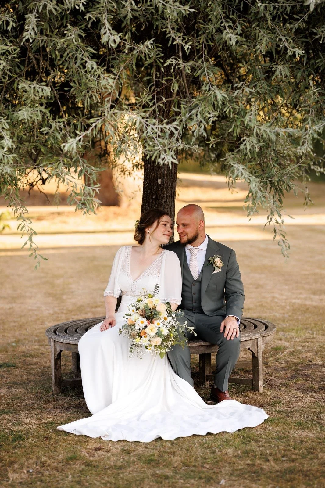 Wedding couple smiling post wedding ceremony delivered and created by Surrey Wedding Celebrant at Loseley Park, Guildford. Photo: Laura Ellen