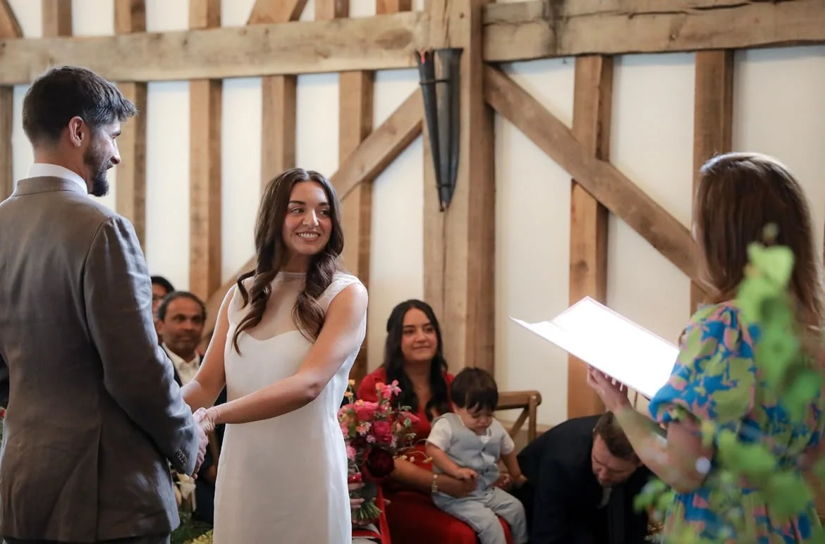 A couple celebrate their wedding ceremony at Gate Street Barn in Surrey, led by an independent Surrey wedding celebrant, creating a relaxed and personalised celebration with family and friends. Photo: VLA Wedding Photography