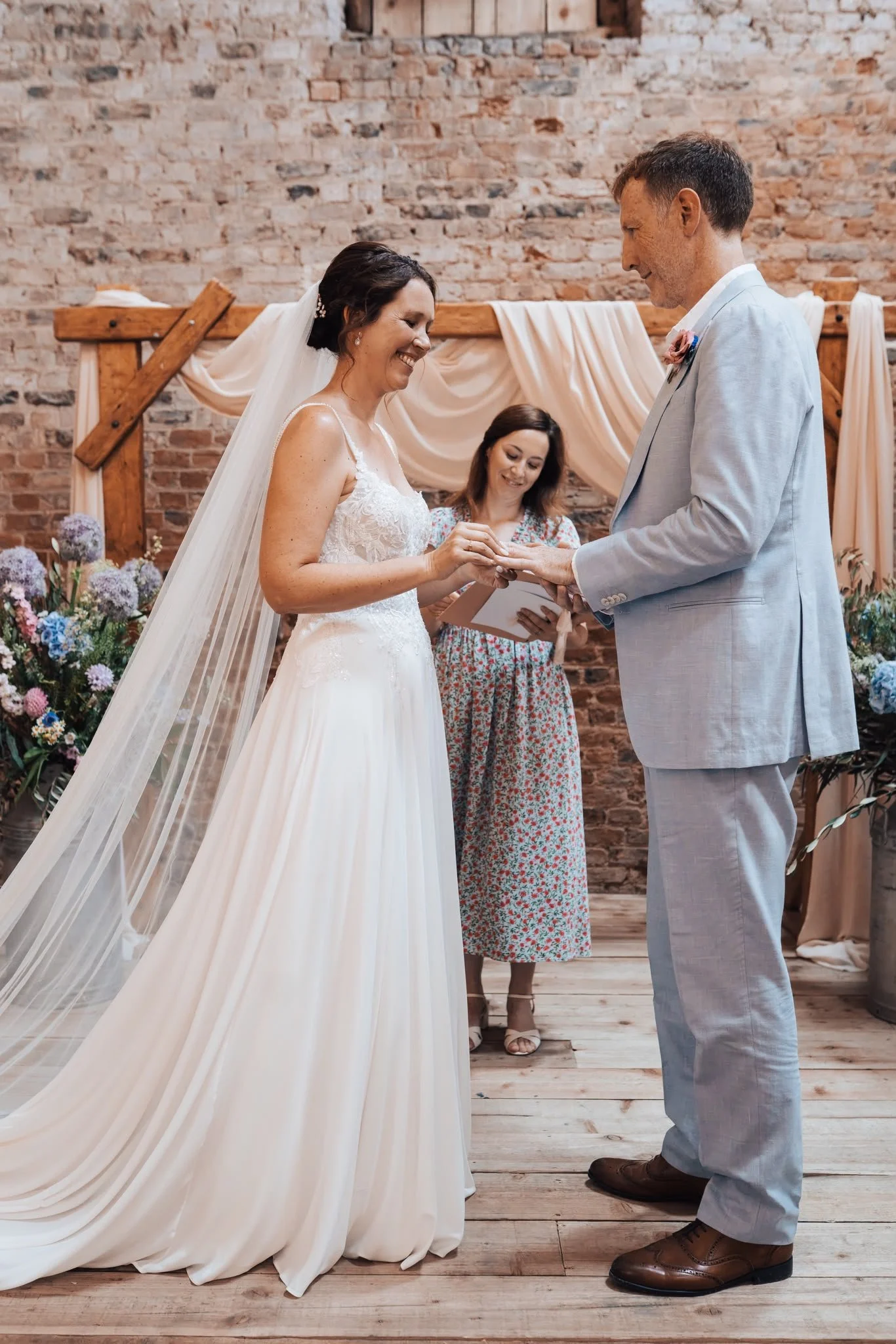 Heartfelt moment between couple during personal vows at celebrant-led wedding ceremony by Surrey Wedding Celebrant at Milton End Barns, The Cotswolds. Photo: Paul Cuthbertson