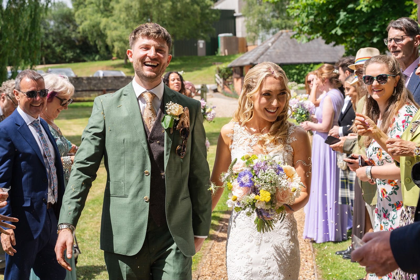 Joyful wedding couple after their celebrant-led wedding ceremony at Sprotts Farm, Colchester by an independent  wedding celebrant working in Surrey and the South of England. Photo: Soulful Reflection