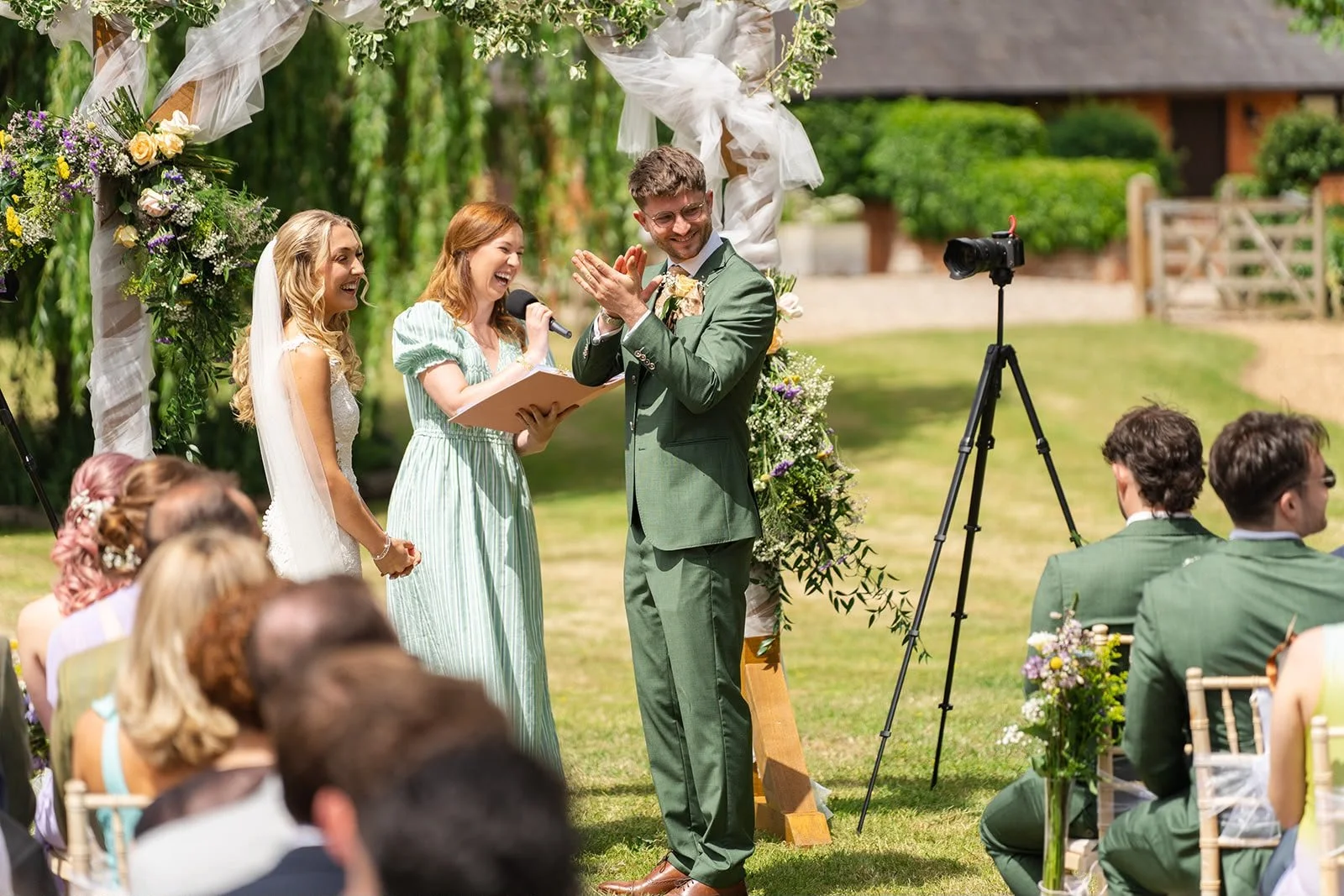 A happy couple celebrate their wedding ceremony at Sprotts Farm in Suffolf led by an independent Surrey wedding celebrant, creating a relaxed and personalised celebration with family and friends. Photo: Soulful Reflection