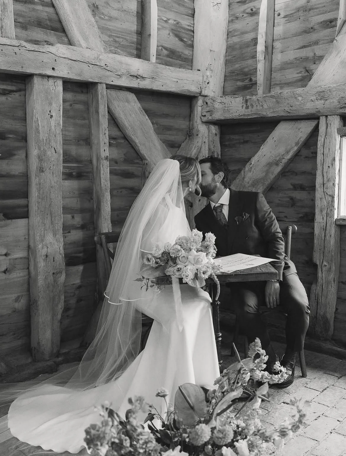 Bride and groom kiss to celebrate their fun and personal  wedding ceremony at High Billinghurst Farm, led by an independent Surrey wedding celebrant. Photo: Leanne Peacock Photography