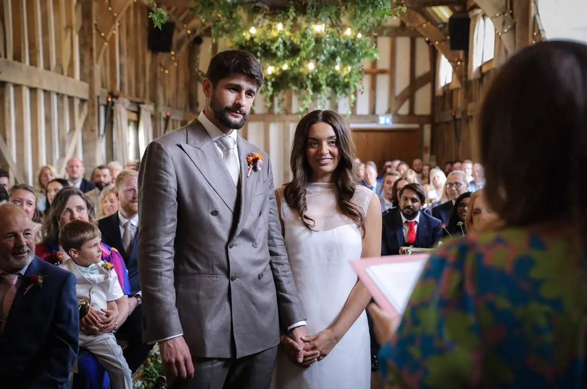 A couple celebrate their wedding ceremony at Gate Street Barn in Surrey, led by an independent Surrey wedding celebrant, creating a relaxed and personalised celebration with family and friends. Photo: VLA Wedding Photography