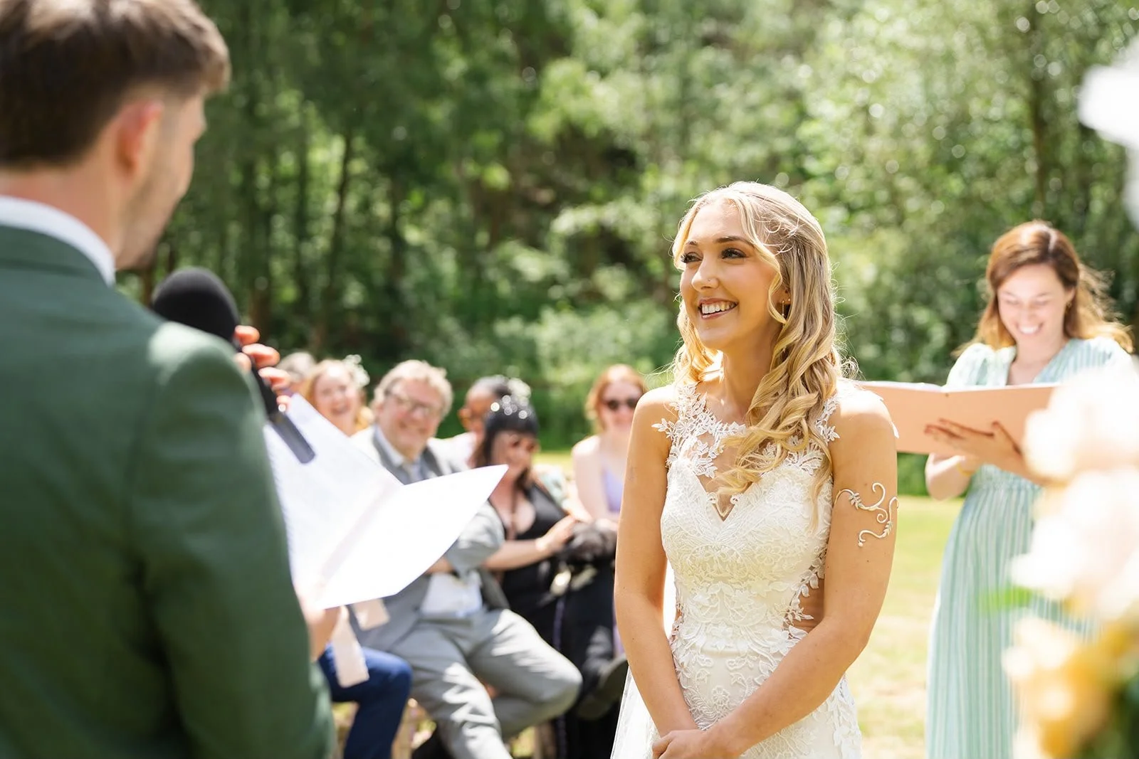 Couple exchange heartfelt personal vows during a celebrant-led wedding ceremony by a Surrey wedding celebrant at Sprotts Farm, Colchester. Photo: Soulful Reflection